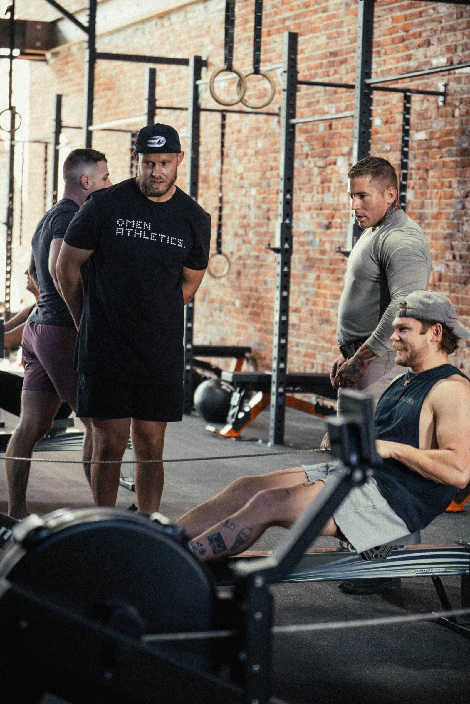 Omen coach supporting members during a workout